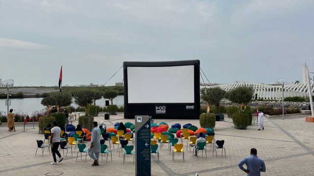 People gather for a large outdoor cinema at Manar Mall.